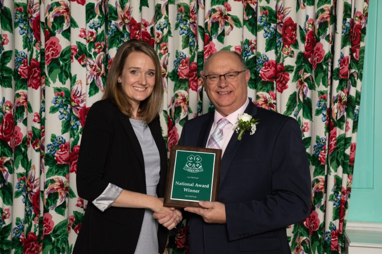 UMaine Extension 4-H professor Kristy Ouellette, left, of Litchfield, accepts her award from NAE4-HA president Tony Carrell.
