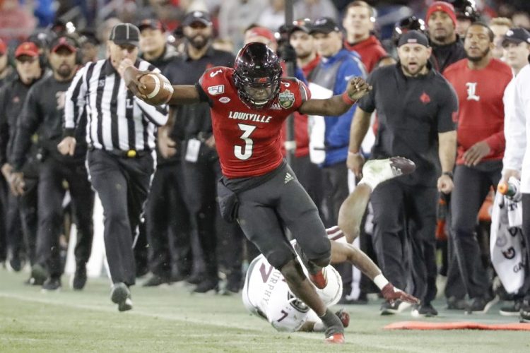Louisville quarterback Micale Cunningham tries to stay in bounds as he carries the ball during the Cardinals’ 38-28 win over Mississippi State in the Music City Bowl on Monday.