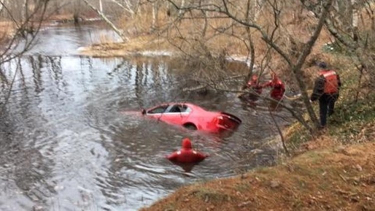 Divers search Moose Pond Brook in West Paris after a car went off Route 26 on Friday morning, killing the driver.