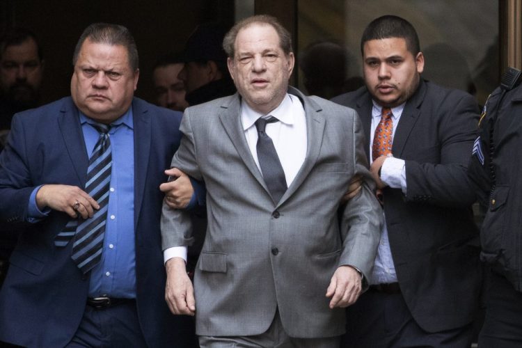 Harvey Weinstein, center, leaves court following a bail hearing Dec. 6 in New York.