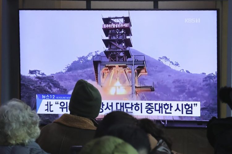 People watch a TV screen showing a file image of a ground test of North Korea's rocket engine during a news program at the Seoul Railway Station in Seoul, South Korea, 
on Dec. 9. North Korea said Sunday it carried out a "very important test" at its long-range rocket launch site that it reportedly rebuilt after having partially dismantled it after entering denuclearization talks with the United States last year.