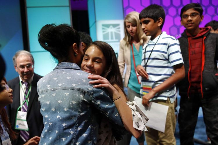 In this Thursday, May 30, 2019, file photo, Simone Kaplan, of Davie, Fla., hugs her mother, Alana, as she walks offstage after reaching the final round of the Scripps National Spelling Bee, in Oxon Hill, Md. The Scripps National Spelling Bee will have fewer participants in 2020, as organizers are reducing the number of wild-card entrants.