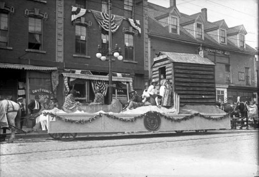 A float featuring a Pilgrim trading post during one of many parades held to celebrate Maine's centennial in 1920.