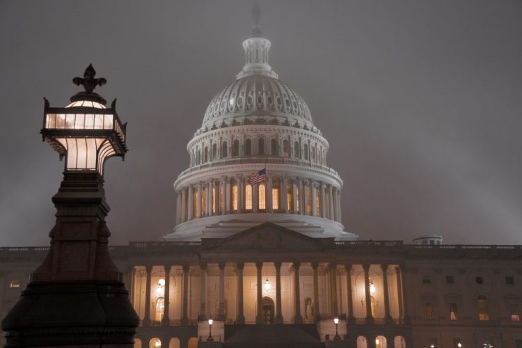 The U.S. Capitol in Washington shrouded in mist. The $1.4 trillion government-wide spending package the House passed Tuesday will forestall a government shutdown this weekend and give President Trump steady funding for his U.S.-Mexico border fence.