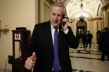 Rep. Mark Meadows, R-N.C., one of President Trump's staunchest defenders, talks on the phone as the House of Representatives debates impeaching the president on Wednesday.