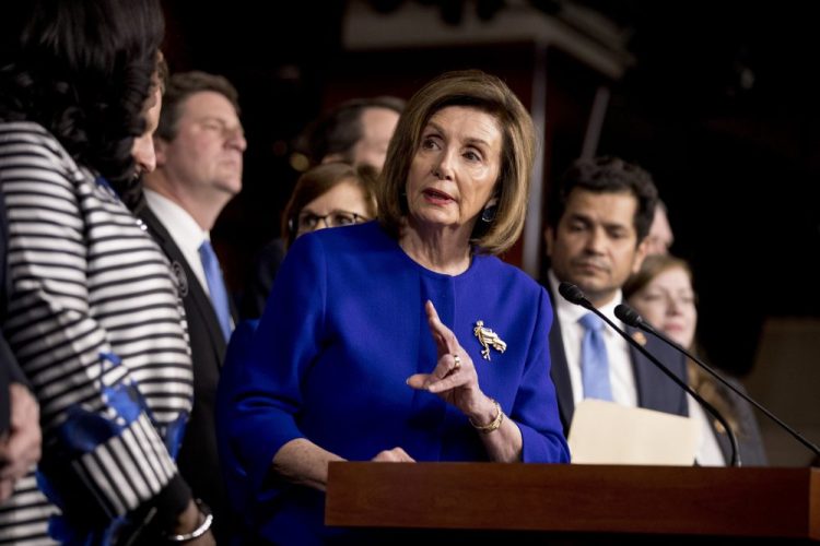 House Speaker Nancy Pelosi of California, accompanied by House  members, speaks at a news conference to discuss the United States Mexico Canada Agreement (USMCA) trade agreement on  Tuesday on Capitol Hill in Washington.