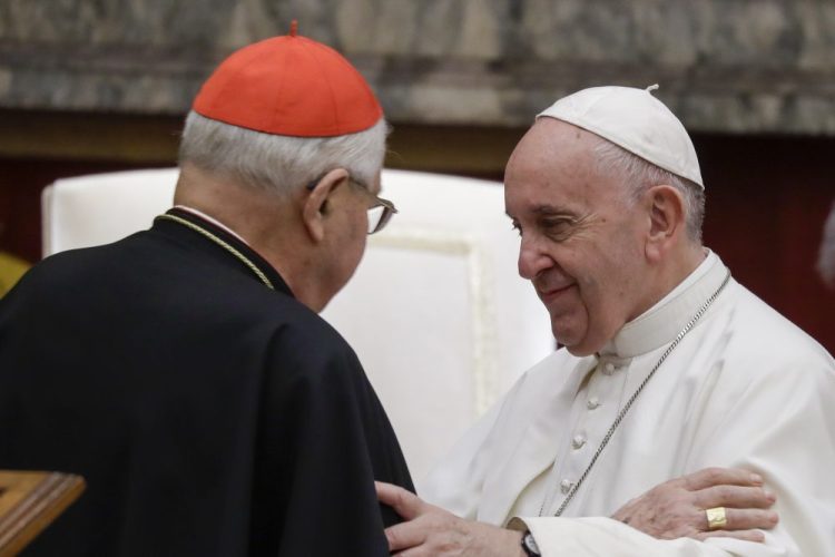 Pope Francis exchanges greetings with Cardinal Angelo Sodano before the pontiff's pre-Christmas address to the Roman Curia at the Vatican on Saturday. 