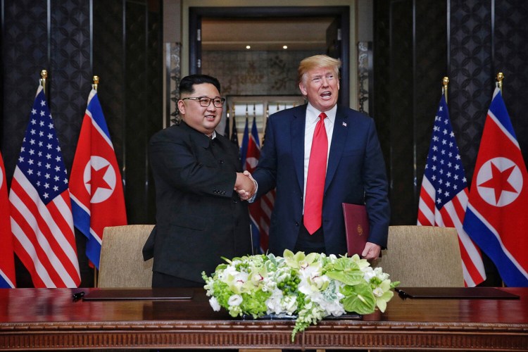 President Donald Trump and North Korean leader Kim Jong Un shake hands after signing an agreement at the Capella Hotel on June 12, 2018, in Singapore.