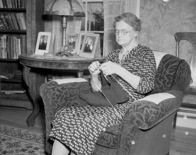 Dec 1941: Mrs. Minetta Paul, of Rockport knits for the troops in the days following Pearl Harbor. 