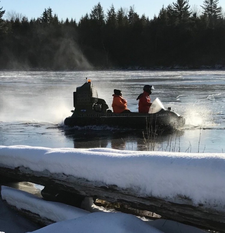 Game Warden Sergeant Ron Dunham maneuvers a hovercraft over the thin ice and towards shore after rescuing a stranded hunter on the river 