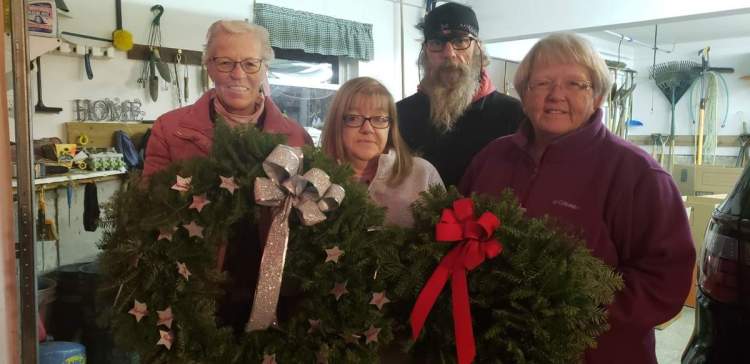 From left, Carla McCorrison, Susan St. Clair, Michael Robinson, and Deborah Dyer display wreaths they and other family members made. The wreaths will be placed at the memorial in Jacksonville, Florida, for the crew of the El Faro.