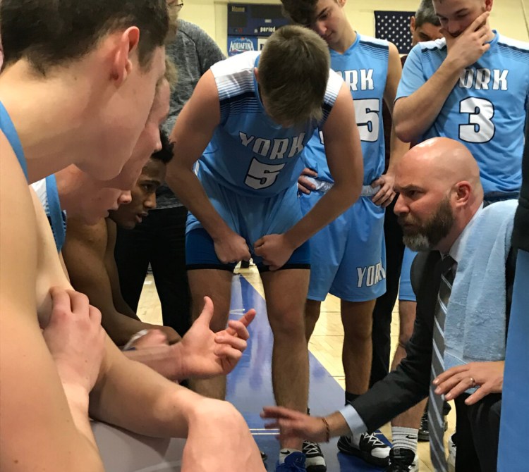 York Coach Paul Marquis instructs his team during a late-game timeout. York beat host Falmouth 68-63 Tuesday to remain unbeaten in Class A South.