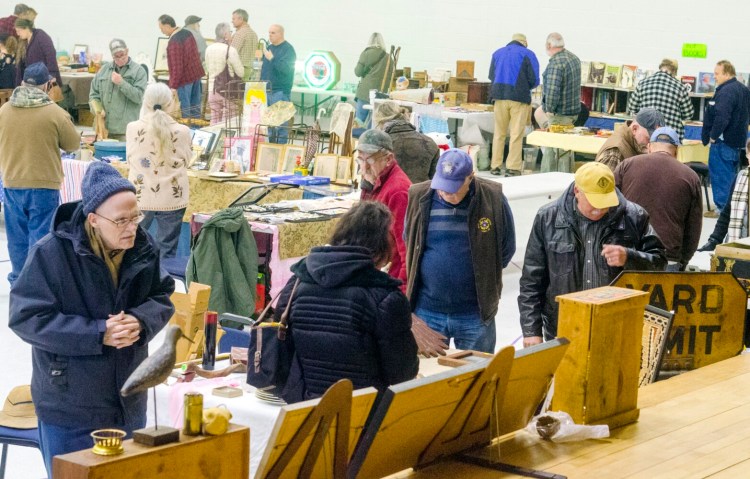 People browse Wednesday during the annual New Year's Day antiques show at the Augusta Armory. Organizer James Montell said that it was the first show of the state's bicentennial year. 