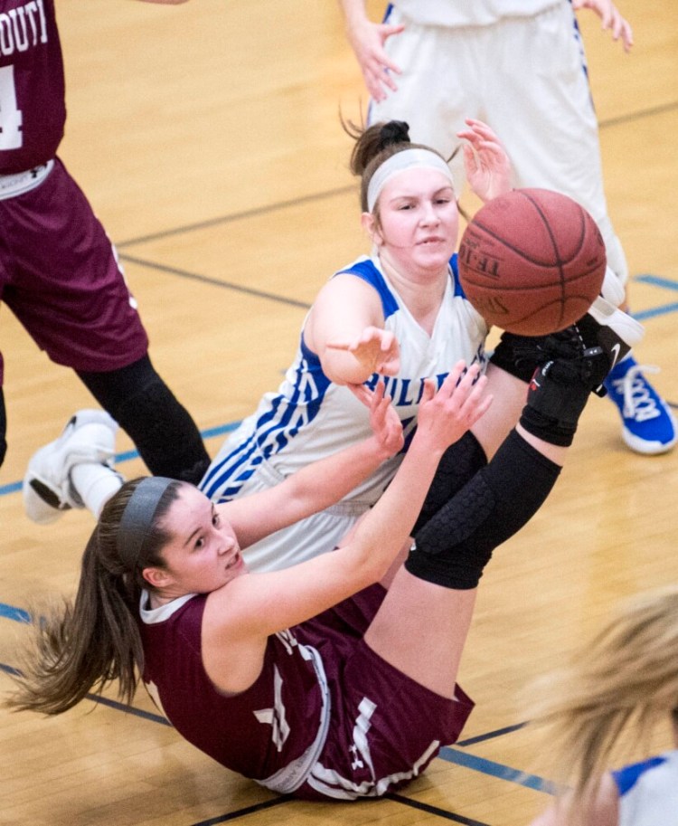 Madison's Brooke McKenney, left, battles for the loose ball with Monmouth's Abby Flanagan during a game Friday in Madison.