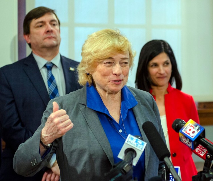 Gov. Janet Mills speaks as Senate President Troy Jackson and House Speaker Sara Gideon listen at Wednesday's news conference announcing Democrats' sweeping health care bill for the coming session.