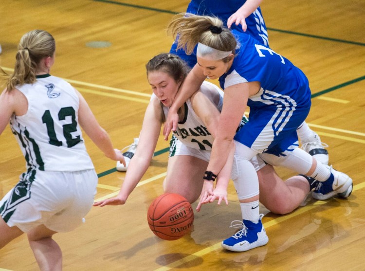 Carrabec's Cheyenne Cahill (11) battles for the loose ball with Madison's Lauria LeBlanc (3) in a Mountain Valley Conference game Wednesday in North Anson.