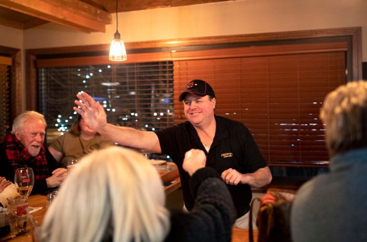 Dennis Coffey walks along the bar high-fiving patrons at Duffy's Tavern & Grill, who watched him repeat as champion in Monday night's "Jeopardy!" show.