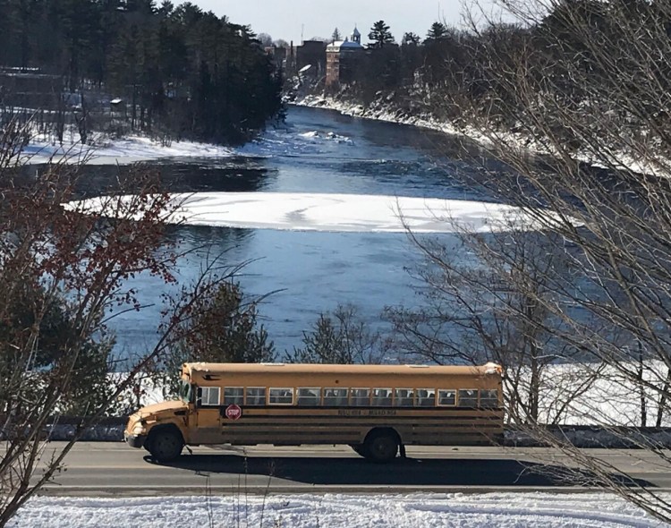 A school bus passes an ice disk Tuesday that floats at the Great Eddy of the Kennebec River off  U.S. Route 2 in Skowhegan. 