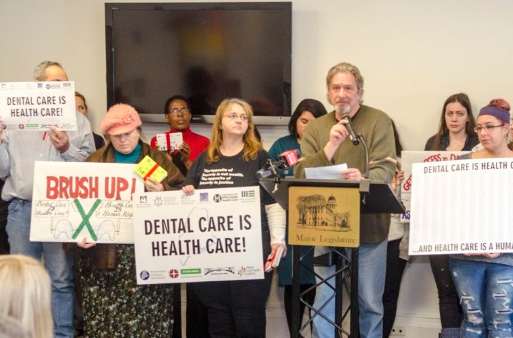 Kirk Robbins, 60, of Portland, from the Southern Maine Workers Center, speaks during a news conference by supporters of a dental health bill  on Thursday at the Maine State House in Augusta. 