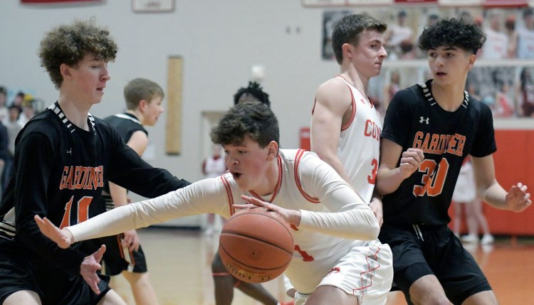Cony sophomore forward Luke Briggs tries to fend off Gardiner defenders during a Kennebec Valley Athletic Conference Class A game Tuesday in Augusta. 