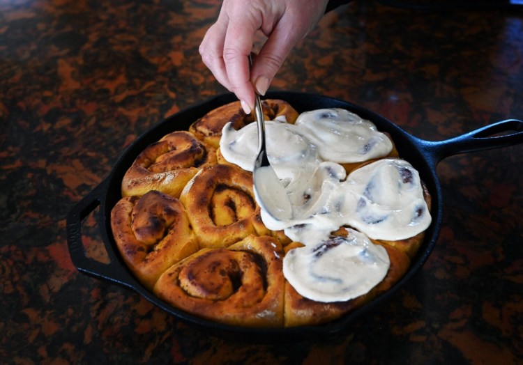 Sweet potato cinnamon buns get a cream cheese frosting sweetened with maple syrup.