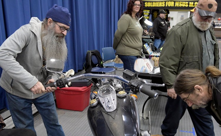 Guests at the Great Northern Motorcycle Swapmeet inspect a 1986 Harley Davidson for sale Sunday at the annual event for bikers in Augusta.