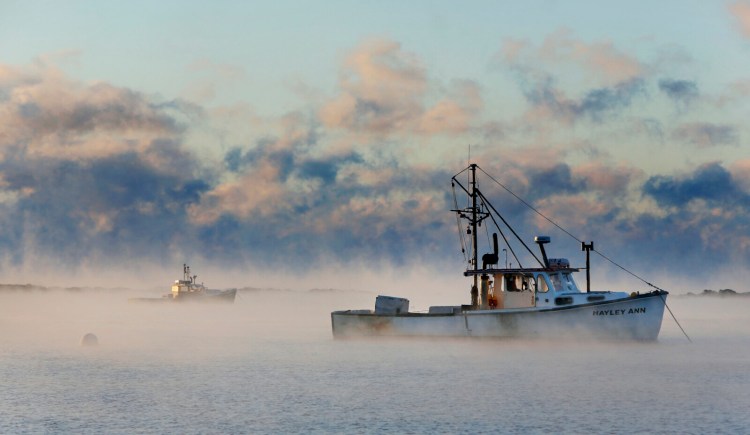 The Hayley Ann is moored amid rising sea smoke in Cape Porpoise Harbor in January 2015. The vessel sank Thursday, and its captain and deckhand died, the Coast Guard said.