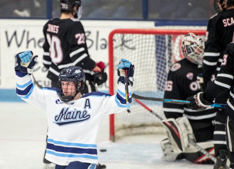 Tim Doherty, left, celebrates a goal against University of Nebraska Omaha in the second period at Alfond Arena at the University of Maine in Orono on Friday. 