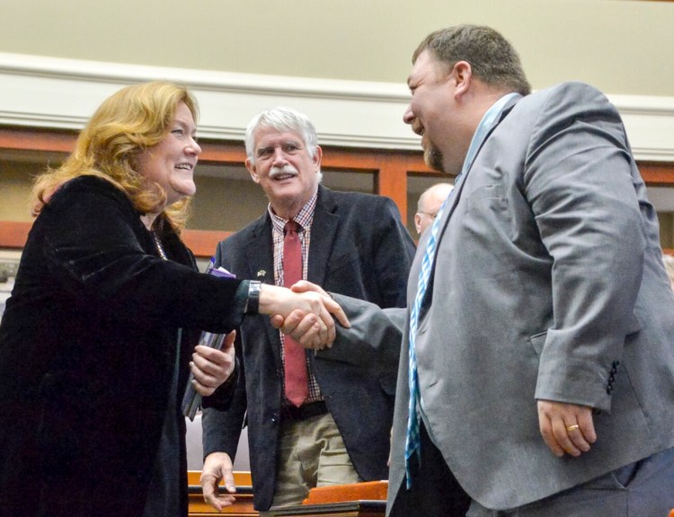 Chief Justice of the Maine Supreme Judicial Court Leigh Saufley, left, greets Rep. Billy Bob Falkington, R-Winter Harbor, right, as Rep. Richard Campbell, R-Orrington, looks on prior to her State of the Judiciary address, Tuesday in the Maine State House's House of Representatives chamber in Augusta.