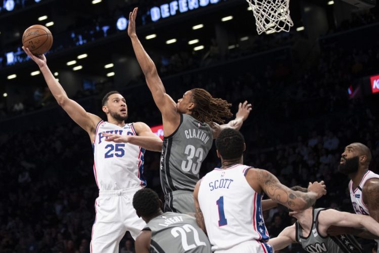 Philadelphia's Ben Simmons goes to the basket against Brooklyn's forward Nicolas Claxton during the 76ers' 117-111 win Monday in New York.