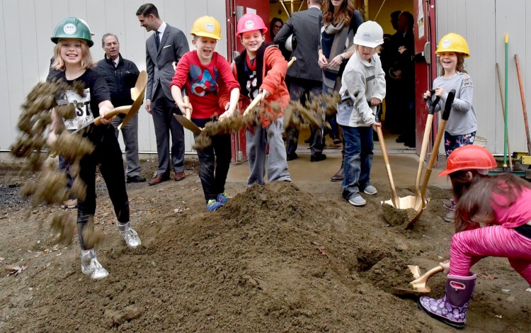 Lilly Howe, from left, Angus Johnson, Nikolai Fay, Silver Picard, Juliet Boivin and Isabella Veilleux got a chance to take part in a groundbreaking ceremony for the Alfond Youth Center Wellness project, flinging dirt toward the photographer on Nov. 1, 2019. The Waterville Planning Board gave conditional approval on Monday to the center to revise its traffic and pedestrian plan.
