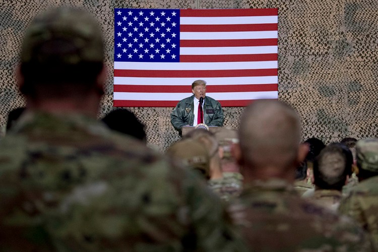 President Trump speaks to U.S. service members at the Ain al-Asad air base in Iraq on Dec. 26, 2018. Iran struck back at the United States for the killing of a top Iranian general by firing missiles at the air base early Wednesday. 