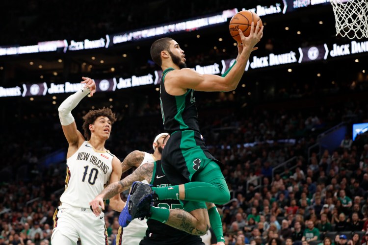 Boston's Jayson Tatum drives past New Orleans' Jaxson Hayes during the Celtics' 140-105 win Saturday in Boston. Tatum finished with a career-high 41.