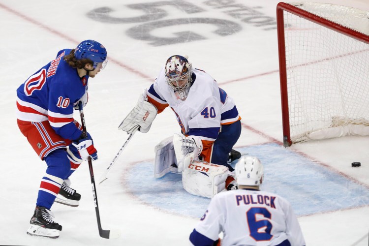 Rangers left wing Artemi Panarin watches his goal slide past New York Islanders goaltender Semyon Varlamov  during the third period of the Rangers' 6-2 win Monday in New York.
