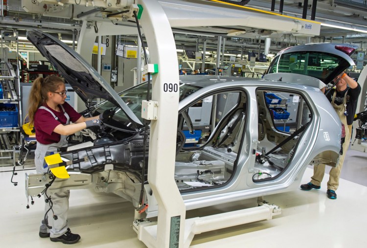File--- Picture taken May 14, 2019 shows complete Golf car bodies at the assembly line during a press tour of the plant of the German manufacturer Volkswagen AG (VW) in Zwickau, Germany. The first ID. production electrical vehicles are to roll off the assembly line at the end of 2019. Only e-cars will be built at Zwickau in 2021. (AP Photo/Jens Meyer)