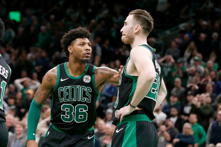 Celtics guard Marcus Smart gives teammate Gordon Hayward a tap after Hayward missed an easy layup on a lob from Smart late in the Celtics' loss to Phoenix on Saturday in Boston.