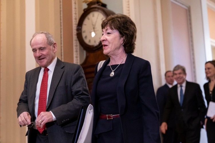 Sen. Jim Risch, R-Idaho, chairman of the Senate Foreign Relations Committee, left, walks with Sen. Susan Collins, R-Maine, as they arrive at the Senate for the start of the impeachment trial of President Trump on charges of abuse of power and obstruction of Congress, at the Capitol in Washington on Tuesday.