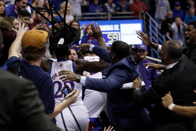 A fight between players spills into the crowd during the second half of Tuesday's game between Kansas and Kansas State in Lawrence, Kan. Kansas defeated Kansas State 81-59. 