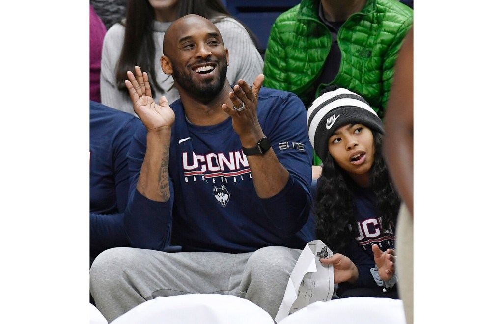 Kobe Bryant and his daughter Gianna watch the first half of an NCAA college basketball game between Connecticut and Houston on March 2, 2019.