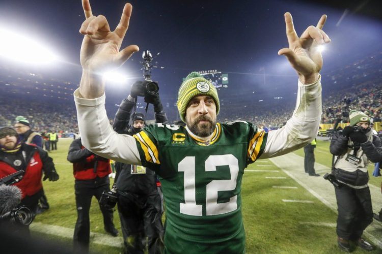 Packers' quarterback Aaron Rodgers signs "I love you" to the Lambeau Field crowd after leading the Packers past the Seahawks and sending Green Bay to the NFC championship game.
