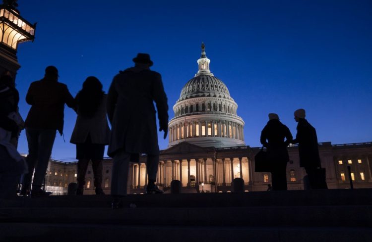 Night falls on the Capitol, in Washington, Wednesday evening during the impeachment trial of President Trump. House prosecutors are outlining what they refer to as President Donald Trump's “corrupt scheme” to abuse power and obstruct Congress as they open six days of arguments in his impeachment trial.