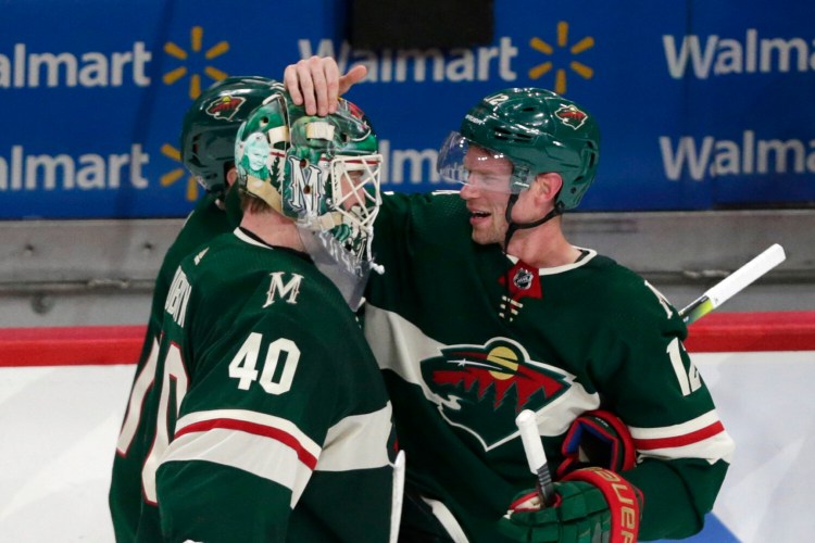 Minnesota Wild center Eric Staal (12) celebrates with Minnesota Wild goalie Devan Dubnyk (40) after defeating the Winnipeg Jets in 3-2 in overtime Saturday in St. Paul, Minn. 