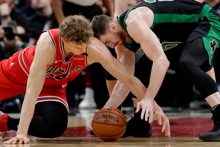 Chicago forward Lauri Markkanen, left, and Boston forward Gordon Hayward compete for the ball during Saturday's game in Chicago