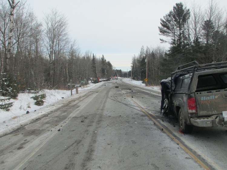 Debris is strewn along Route 2 in Canaan on Saturday morning after a fatal collision between a pickup truck and a pulp truck. According to Somerset County Sheriff's Department, one man was killed and two others were injured. 