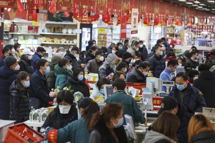 Shoppers pay for their groceries at a supermarket in Wuhan, China, on Saturday. 