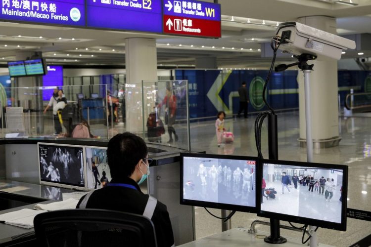 A health surveillance officer monitors passengers arriving at the Hong Kong International airport in Hong Kong this month. The U.S. Centers for Disease Control and Prevention says it will begin screen airline passengers at three U.S. airports who traveled from Wuhan in central China, for a new illness that has prompted worries about a new international outbreak. 