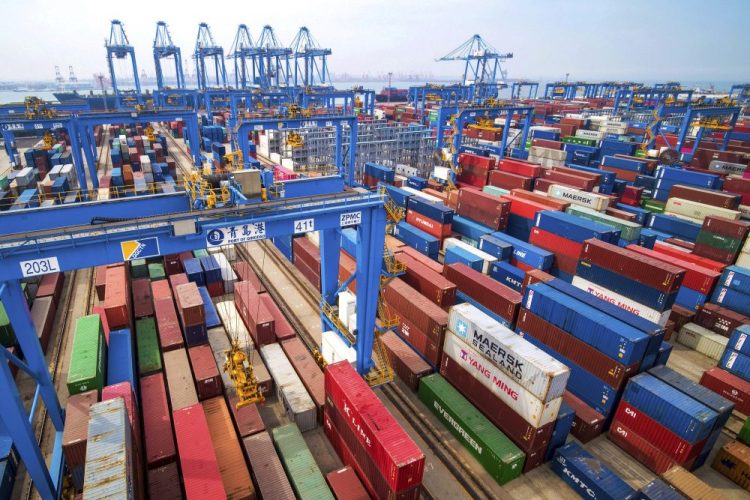 In this Tuesday, May 14, 2019, file photo, containers are piled up at a port in Qingdao in east China's Shandong province. 