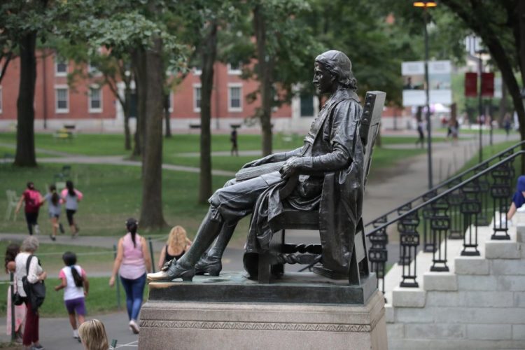 The statue of John Harvard sits in Harvard Yard at Harvard University in Cambridge, Mass. 