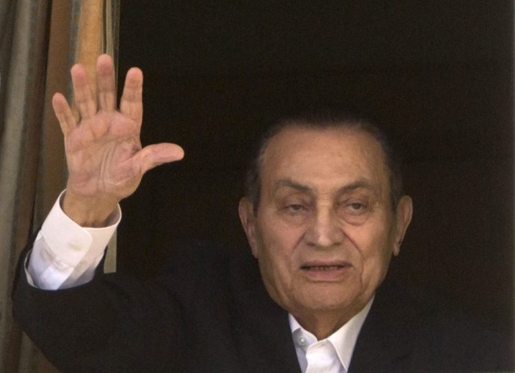 Ousted Egyptian President Hosni Mubarak waves to his supporters from his room at the Maadi Military Hospital, where he was hospitalized in Cairo in 2016. 