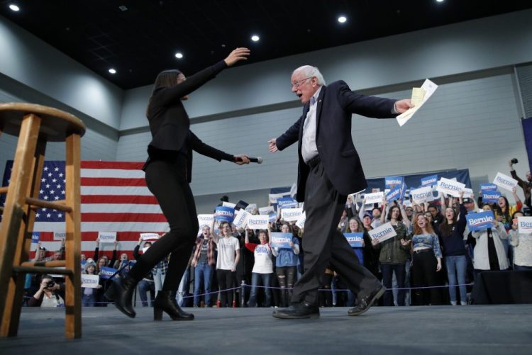Democratic presidential candidate Sen. Bernie Sanders, I-Vt., right, embraces Rep. Alexandria Ocasio-Cortez, D-NY, at a campaign rally Sunday in Sioux City, Iowa.